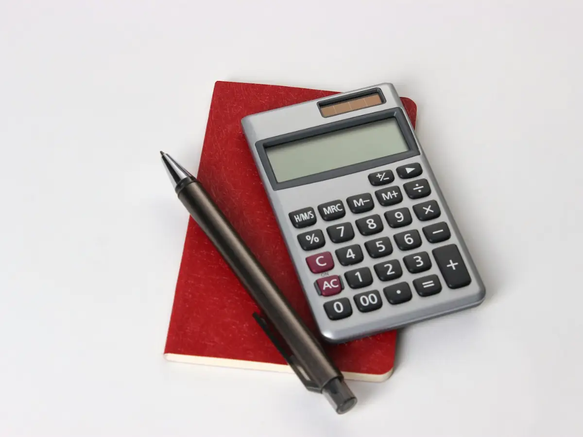 Calculator and pen used to work out air conditioning installation cost for a home