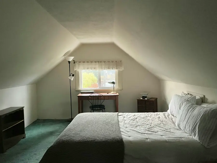 Attic bedroom with a window set into the sloped roof