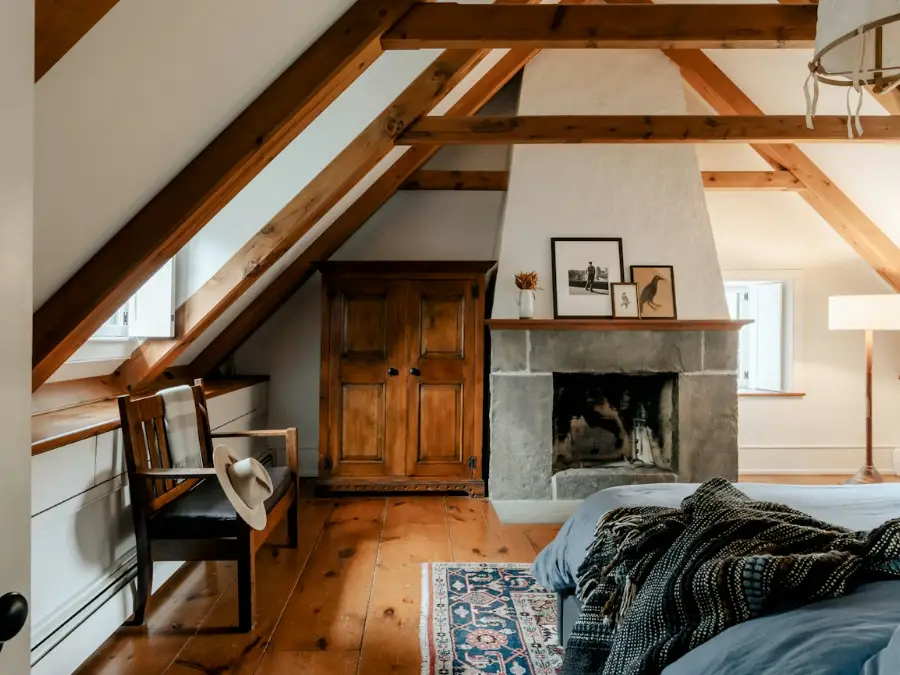 Attic lounge with timber beams and a sofa under the roof