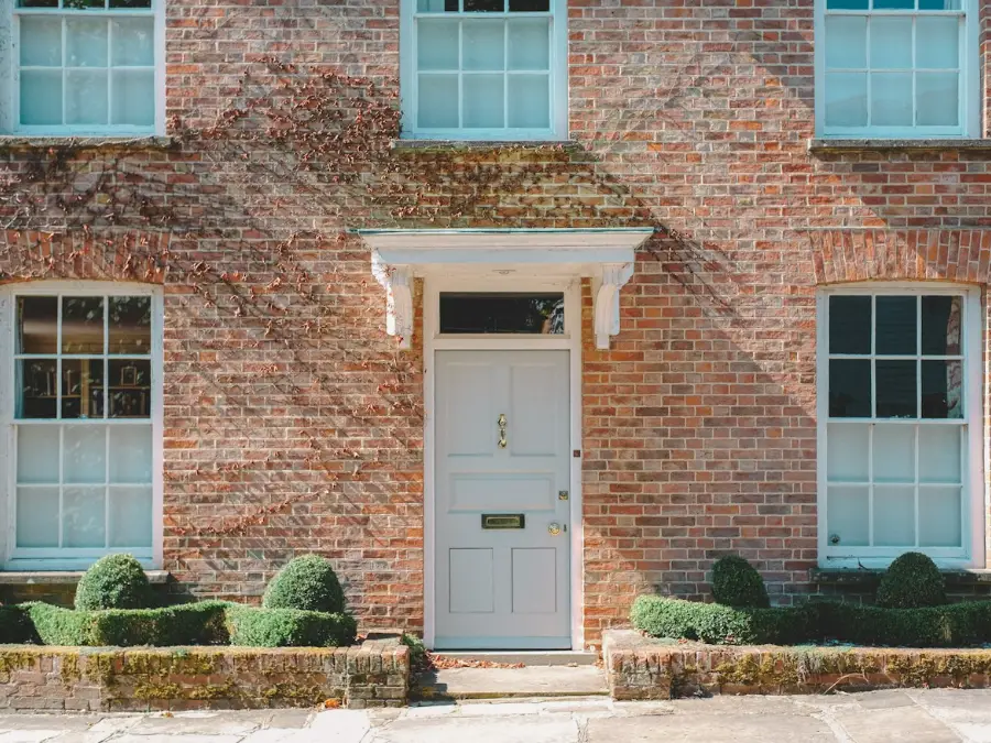 Front door of a brick house on a residential street