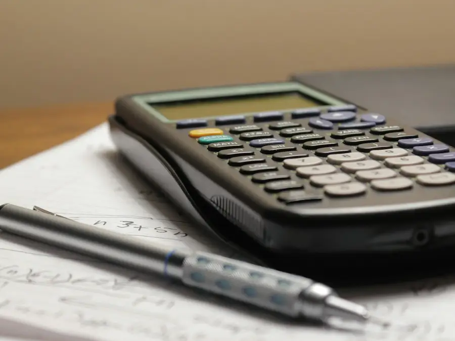 Calculator and pencil on a desk for comparing air conditioning quotes