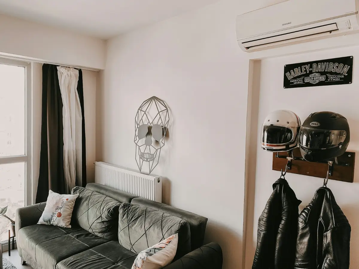 Daikin air conditioning installation in a bright living room, with the indoor unit high on the wall