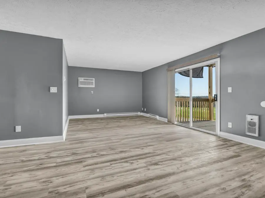 Empty room with a new wooden floor ready for an indoor unit to be fitted