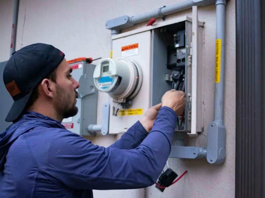 Engineer testing electrical connections with a meter during a service visit