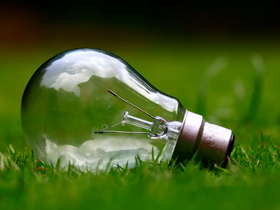 Energy saving light bulb glowing against a dark background