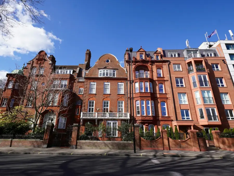 Red brick mansion flats on a sunny London street