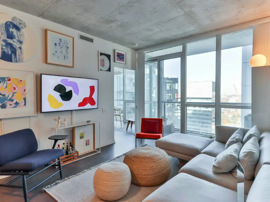 Modern open plan flat living space with a sofa and large windows