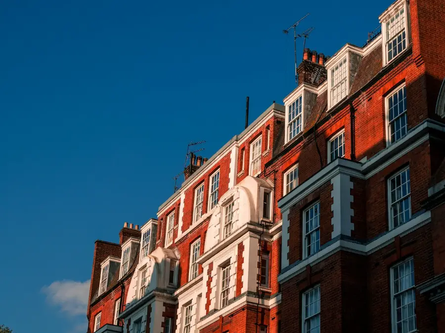 Red brick mansion flats with bay windows facing the street