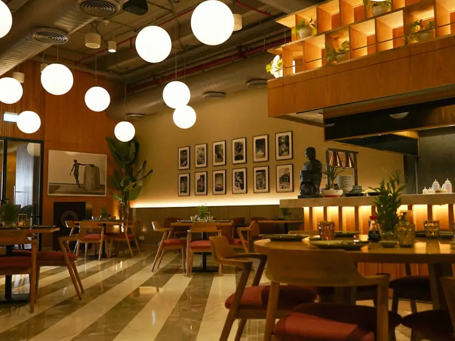 Warmly lit restaurant dining room with tables set for service